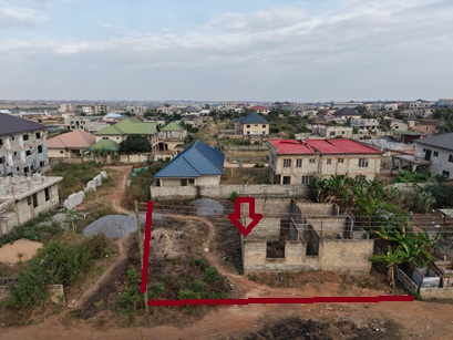 Plot of land with an uncompleted storey for sale.