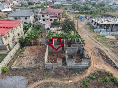 Plot of land with an uncompleted storey for sale.